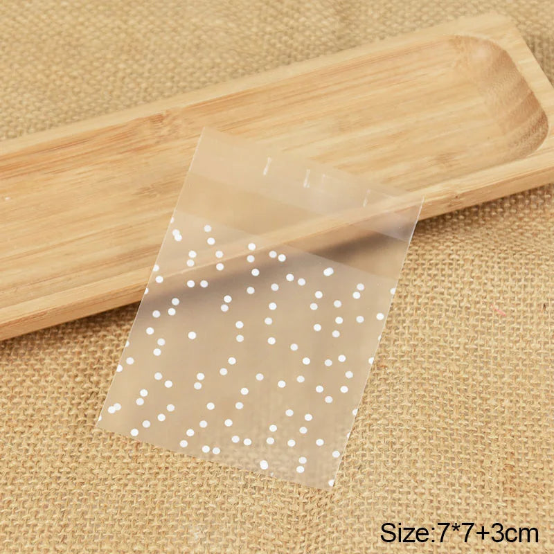 Transparent dot candy cookie bags for DIY storage placed on a wooden board