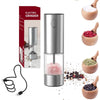 A silver electric grinder for salt and pepper, shown with its charging cord and a bowl of ground spices.