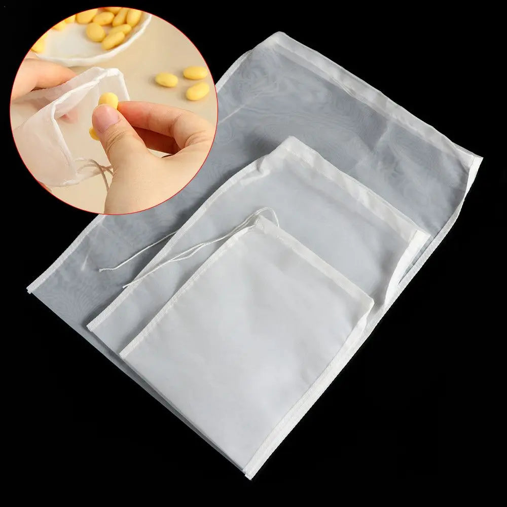 A white reusable fine mesh food strainer colander is shown in a clear plastic bag with a drawstring.