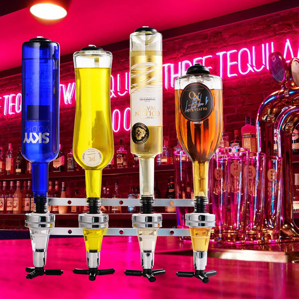 Three glass rotating wall dispensers filled with colored spirits displayed on a bar counter.