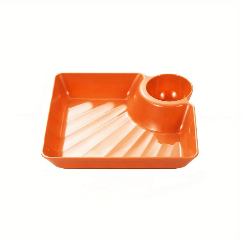 An orange serving plate with a bowl section for appetizers or charcuterie.