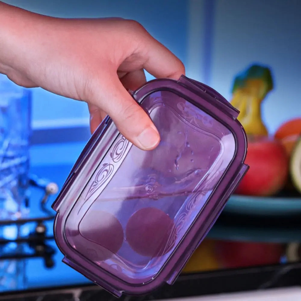 A hand is opening a purple airtight refrigerator storage box.