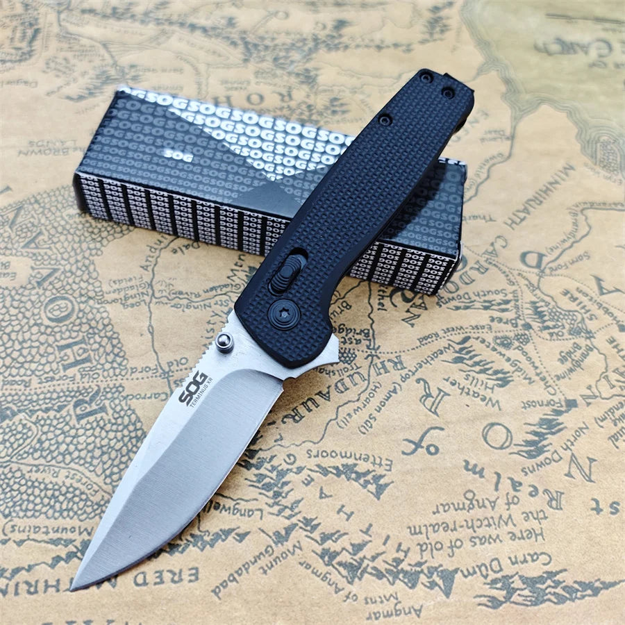 A black folding pocket knife with a silver blade rests on a piece of aged paper map.