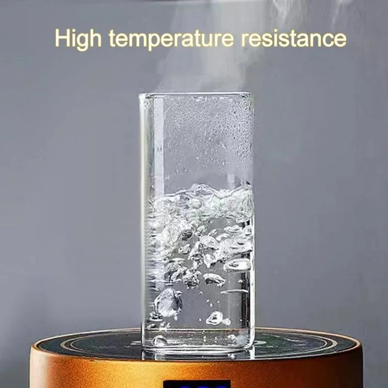 A clear glass cup filled with ice and water on a wooden coaster, demonstrating high temperature resistance.
