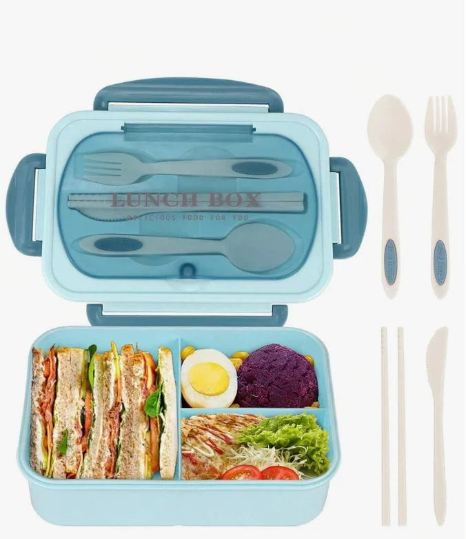 A light blue bento box set featuring a lid and a compartment filled with sliced meats, vegetables, and rice.