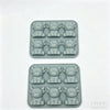 A set of reusable silicone ice cube molds for cocktails, showing multiple molded shapes.