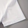 A close-up view of a white t-shirt sleeve folded on a gray surface.