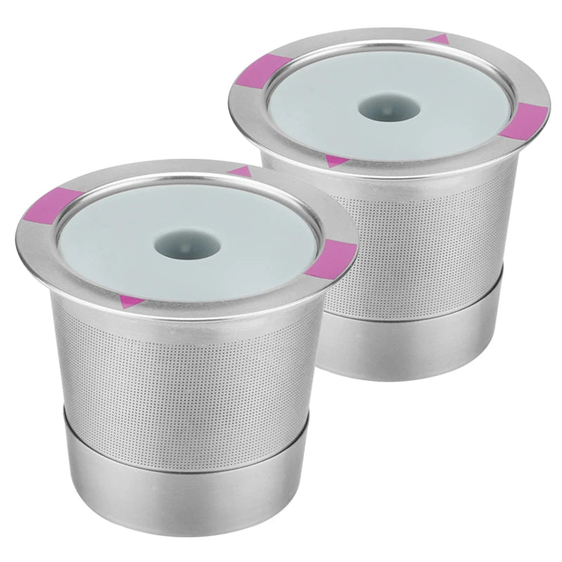 Two reusable stainless steel K-cup coffee filters stacked together.
