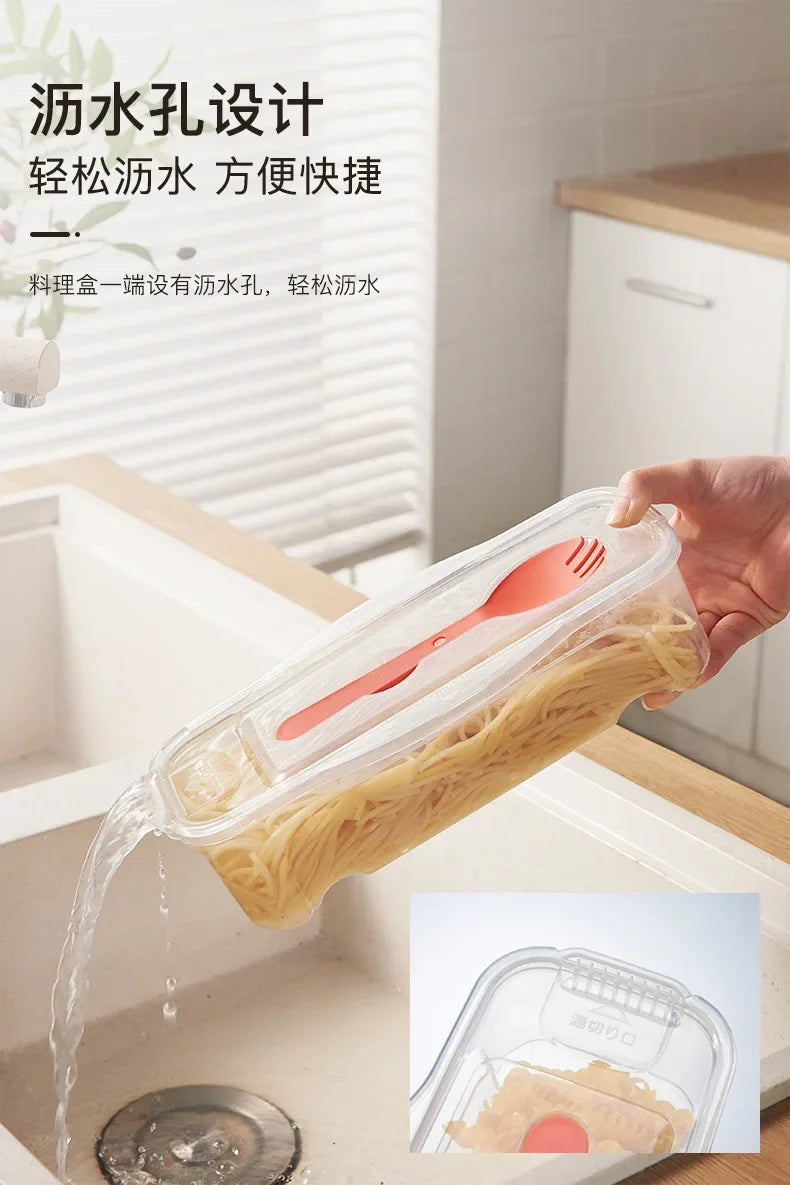 A hand is pouring noodles from a clear plastic container into a sink, demonstrating the use of a microwave noodle and salad c