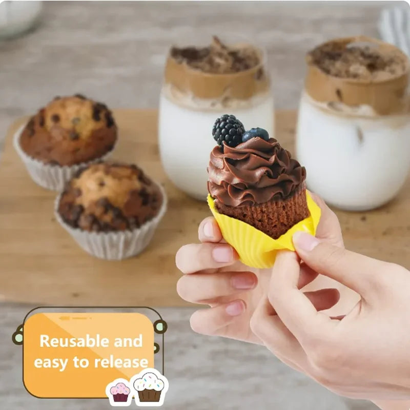 Hands holding a chocolate cupcake with a swirl of frosting and fresh berries, demonstrating the reusable silicone baking mold