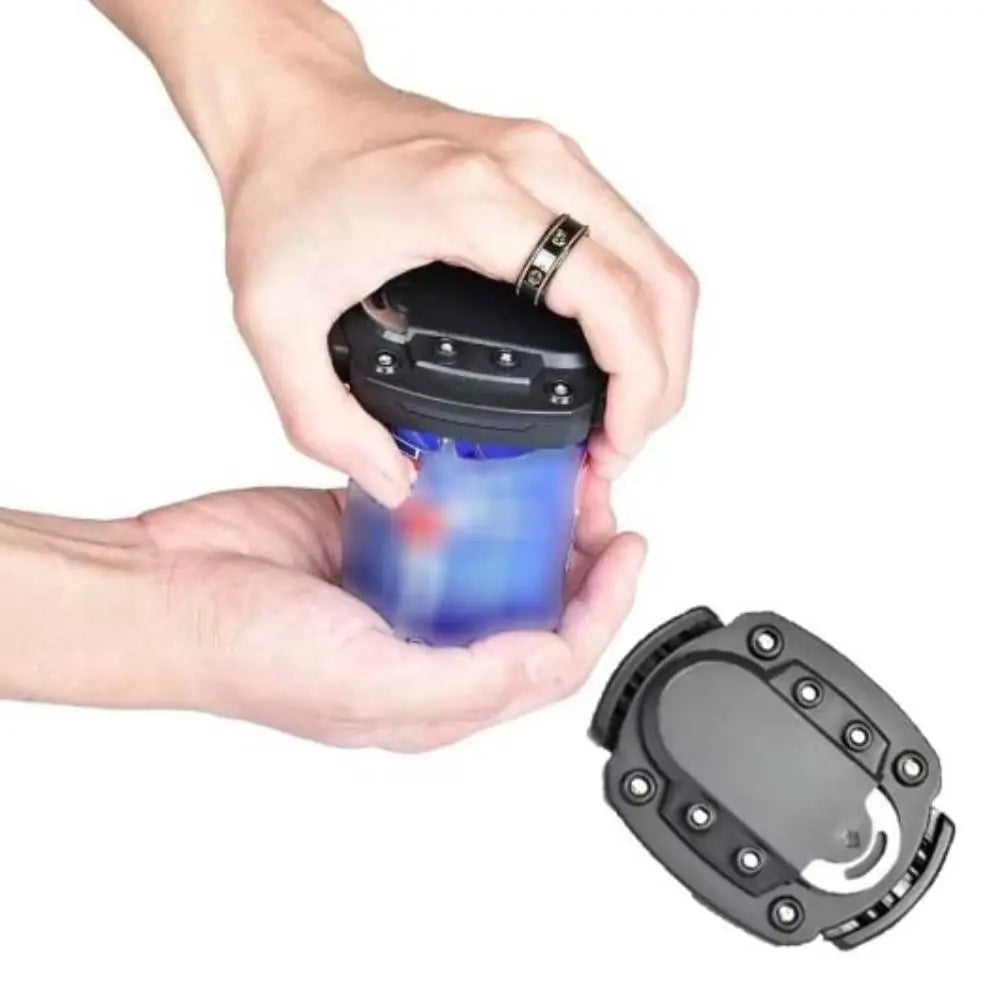 A hand holds a black beverage opener tool with a blue liquid inside, demonstrating its use.
