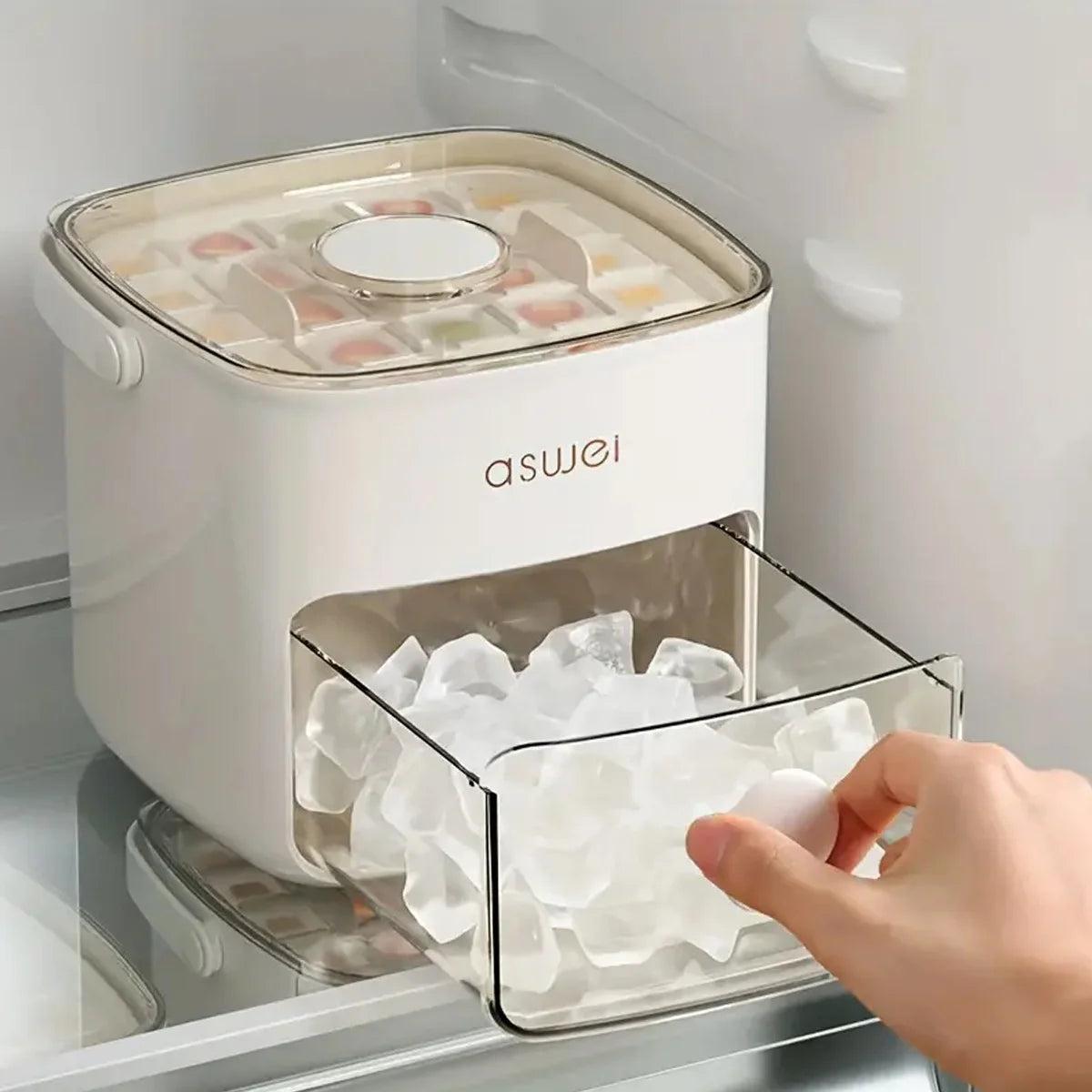 A hand is placing ice cubes into a clear compartment of an asuei 48-grid ice cube maker in a refrigerator.