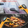 An orange digital infrared thermometer is used to measure the surface temperature of food in a pan.