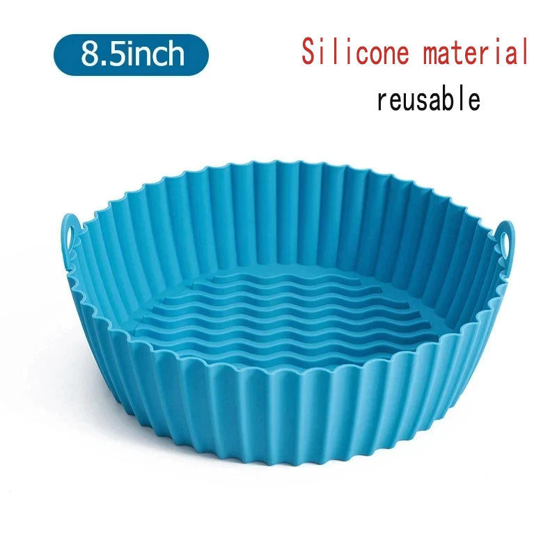 A teal silicone reusable baking pan with fluted sides, labeled as an 8.5-inch size.
