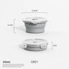 Contenedor de silicona gris plegable para almacenar alimentos, con sus dimensiones marcadas.