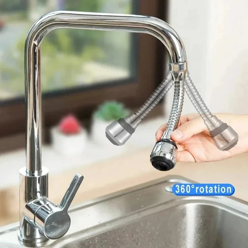 A hand is operating a chrome kitchen faucet with a 360-degree rotating spray head.