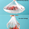 A hand is placing a clear plastic food cover over fresh strawberries, demonstrating good bearing capacity and no water leakag