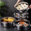 A stack of stainless steel steamers containing steamed corn on the cob and potatoes.