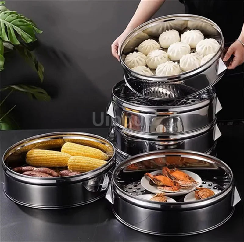 A stack of stainless steel steamers containing steamed corn on the cob and potatoes.