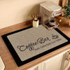 A square black mat with a beige textured surface features elegant script text reading Coffee Bar Fresh Coffee Daily Love Coff