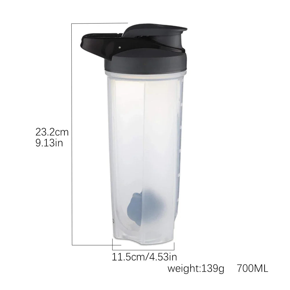 Clear plastic protein shaker bottle with a black lid and blender whisk