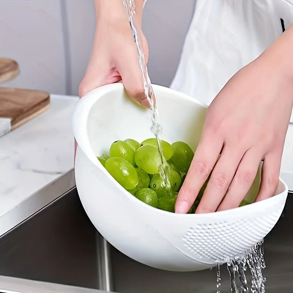 Hands are pouring juice from green grapes into a white bowl using a multi-purpose kitchen strainer.