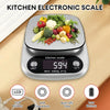 A digital kitchen scale shows various fresh vegetables on a wooden surface, featuring an LCD display and battery icon.