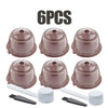 Six reusable coffee capsule pods in a brown color with white lids and black caps.