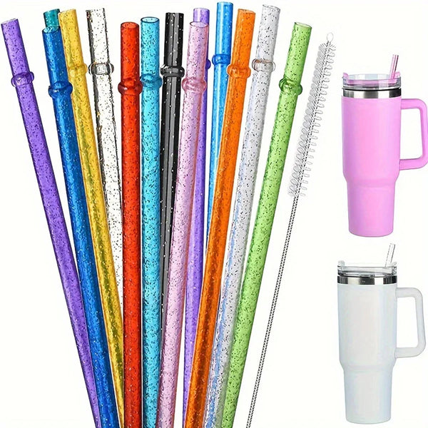 A collection of colorful glitter reusable plastic straws with cleaning brushes displayed vertically.