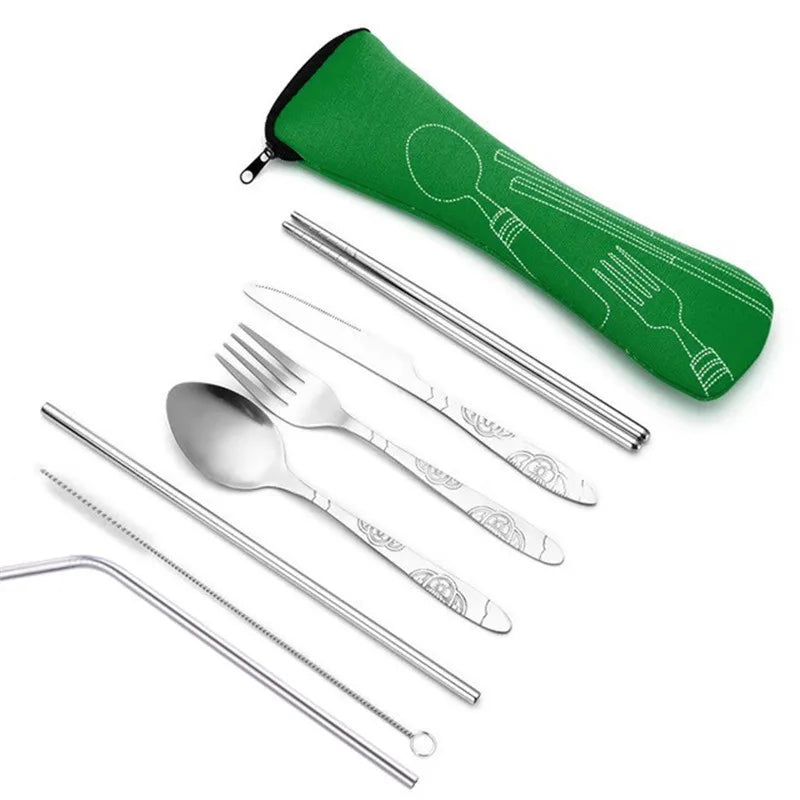 A green storage case holds a set of stainless steel cutlery including forks, knives, and spoons.