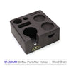 A dark wood coffee portafilter holder with multiple sized cups and a small metal fitting.
