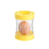 A yellow manual hand crank egg shell remover with a clear glass container and an egg inside.