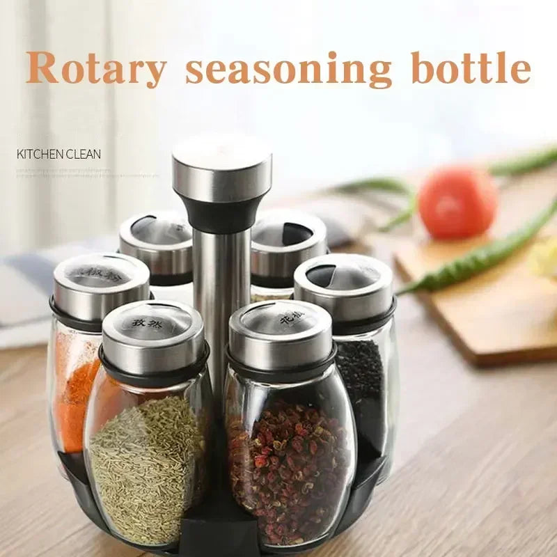 A set of rotating seasoning bottles filled with various spices arranged on a wooden surface.