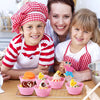A mother and son smiling while decorating cupcakes using reusable silicone liners.