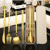 A set of reusable stainless steel cutlery including a fork, knife, and spoon displayed next to a rectangular silicone holder.