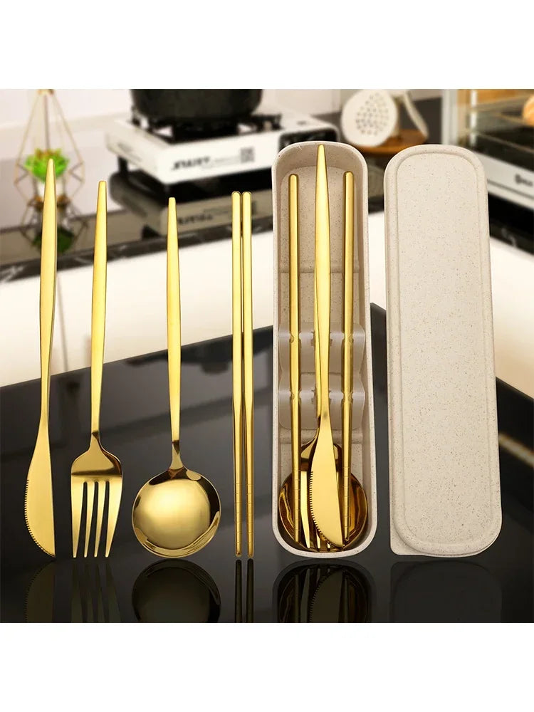 A set of reusable stainless steel cutlery including a fork, knife, and spoon displayed next to a rectangular silicone holder.