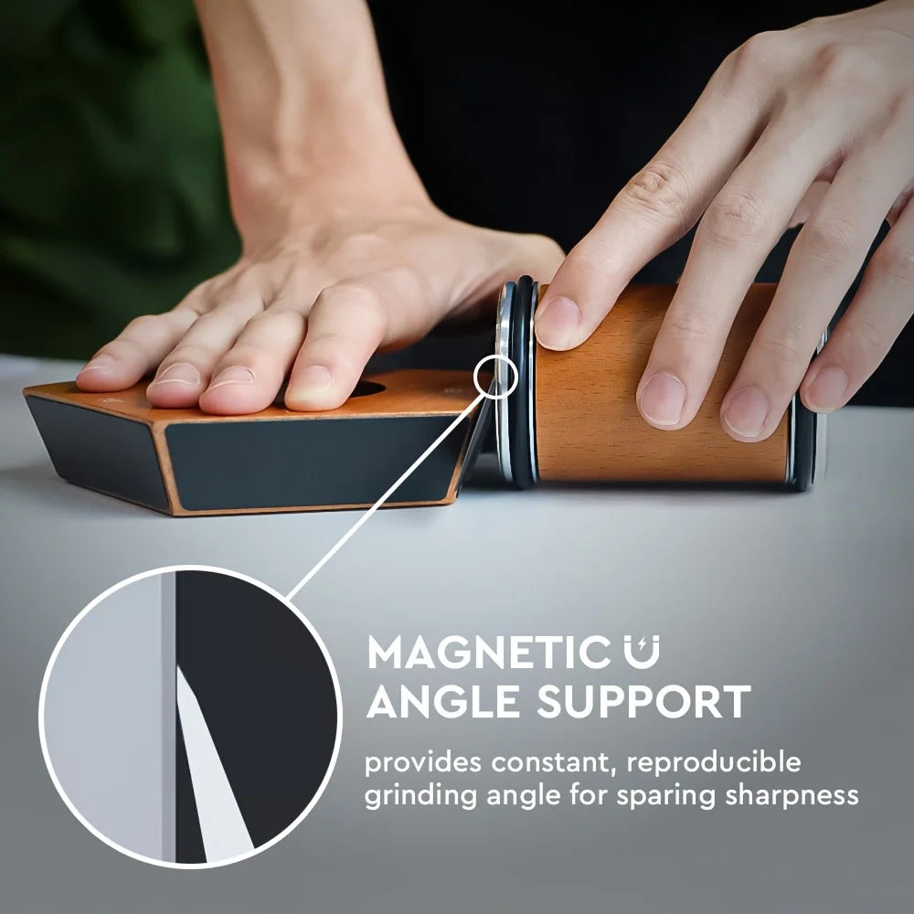 A hand holds a wooden knife sharpener demonstrating magnetic angle support for grinding.