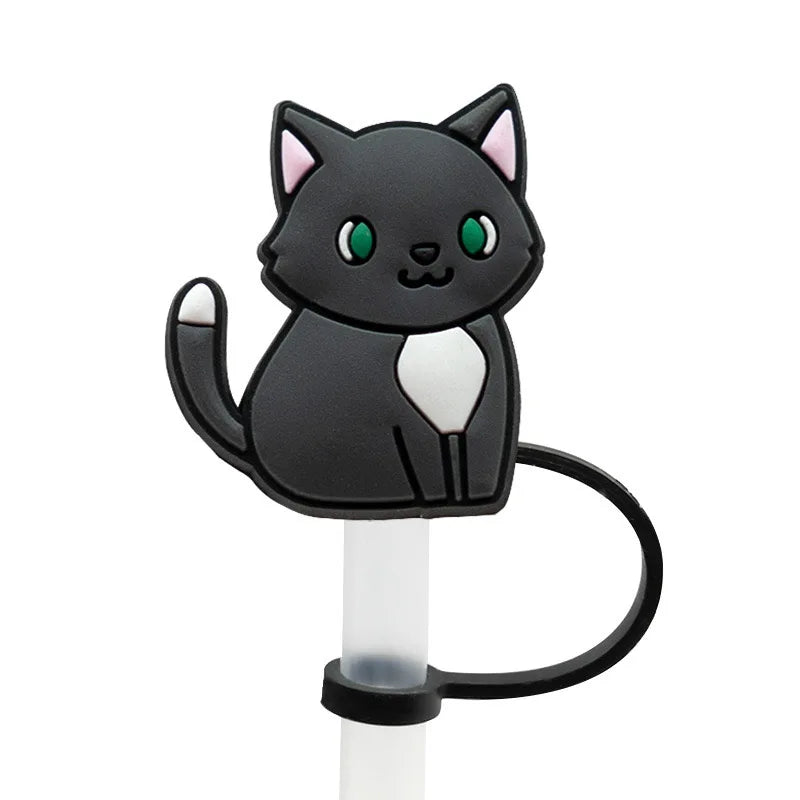 A black cat silicone straw cover with green eyes and pink ears mounted on a white stick.