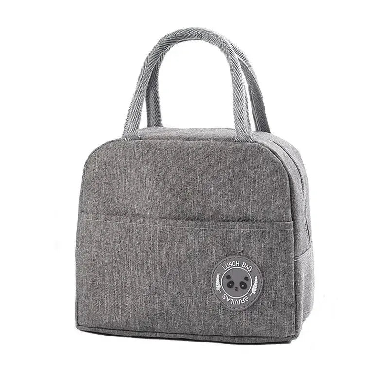 A gray insulated bento lunch bag with a woven strap and a circular logo on the front.