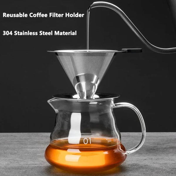 A reusable stainless steel coffee filter holder dripping brewed coffee into a glass cup.