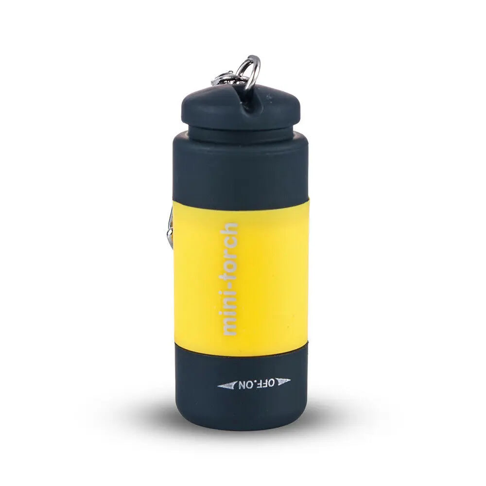 A small, dark gray and yellow mini-torch flashlight with a metal keychain clip.
