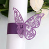 Purple laser cut butterfly napkin rings attached to a white cylindrical object.
